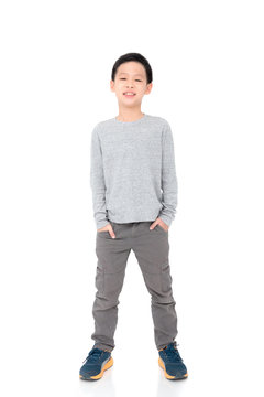 Young asian boy standing over white background