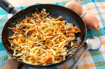 Frying pan of cabbage and two onions  