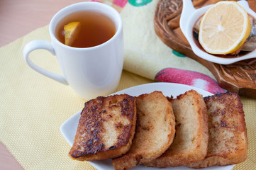 Crispy fresh toast and tea with lemon  