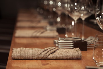 Fototapeta na wymiar Folded napkin laid on the table for dinner at restaurant with vi