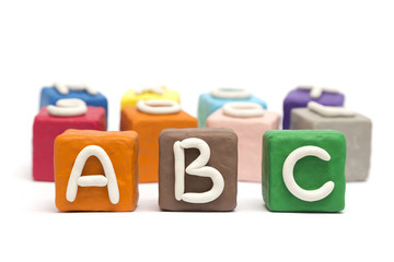 Cubes made of modeling clay with letters