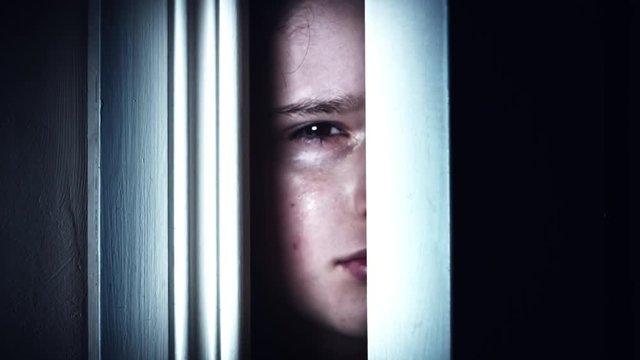4K Thriller Child Eye Looking through Door Gap and Crying