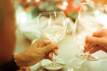 Blurry background luxury dinner party with two men clink glasses