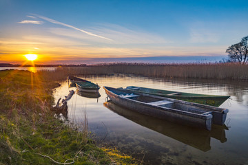 fishing boats on the lake during sunset, lake Miedwie, Poland