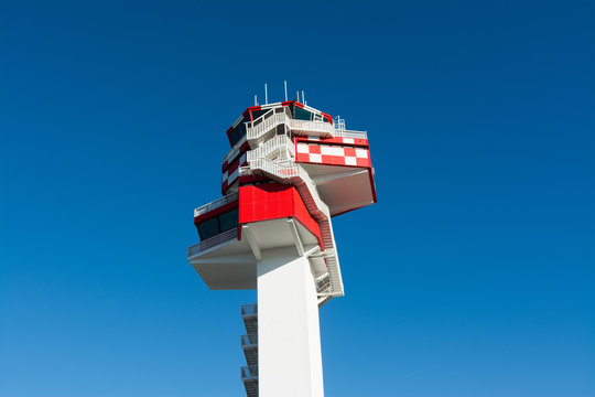 Airport, air traffic control tower in white and red. Rome, Italy