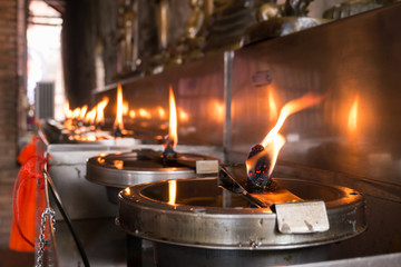 Close up candle oil light in Temple, Thailand