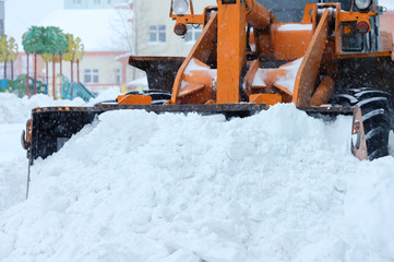  Snow clearing. Tractor clears the way after heavy snowfall.