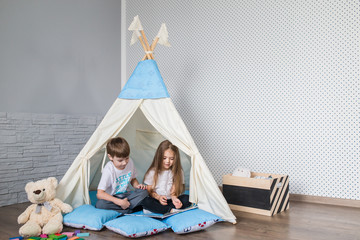 Child playing with a teepee tent © familylifestyle