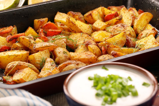 Baked potatoes with herbs and white dip