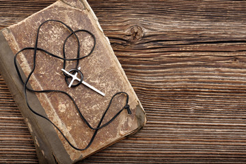 Very old holy bible and metal cross necklace with ring