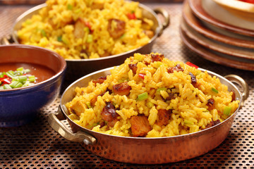 Chicken with basmati rice fried in stainless pan