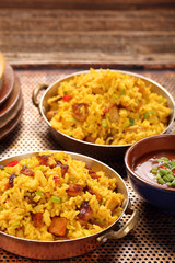 Chicken with basmati rice fried in stainless pan