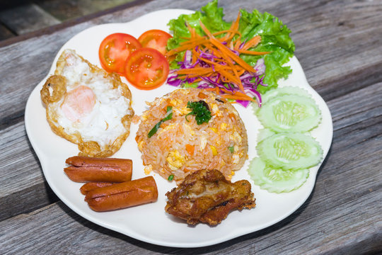 American fried rice on plate on wood table
