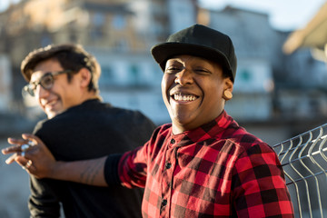 two guys joking and laughing on the street