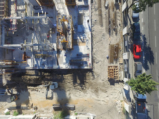 Aerial view of a gigantic construction site with the street on the side