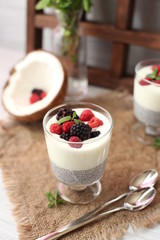 Fresh homemade coconut yogurt in glass cups served with fresh berries