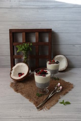 Fresh homemade coconut yogurt in glass cups served with fresh berries