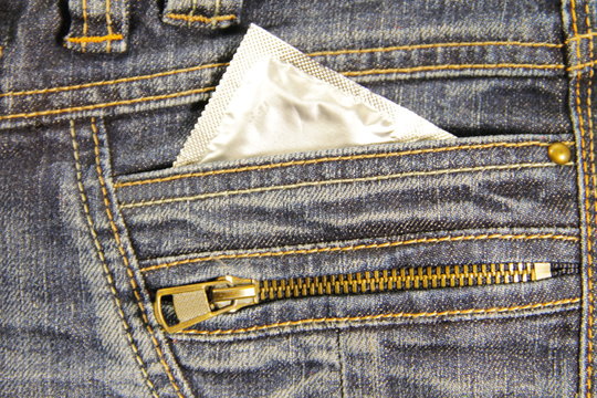Condom in the pocket of a blue jeans