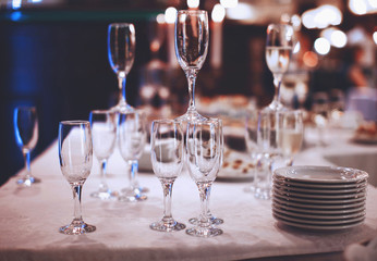 Wineglasses with plates on table service at banquet