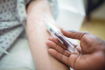 Doctor collecting blood sample from the patient