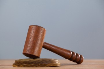 Wooden gavel placed on wooden table