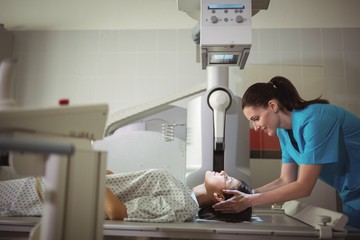 Female patient undergoing an x-ray test - obrazy, fototapety, plakaty