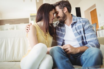 Happy couple relaxing on sofa