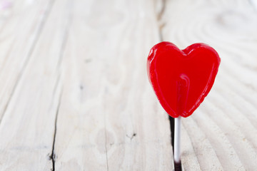 Valentine day concept - heart shaped lolly pop on wood backgroun