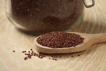 Black Quinoa on a wooden spoon