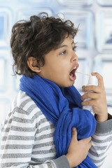 Boy uses a spray for the throat 