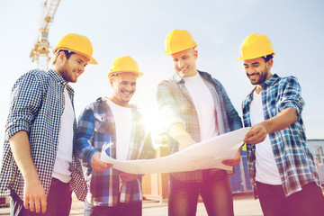 group of builders with tablet pc and blueprint