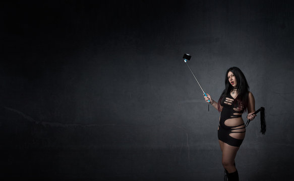 mistress, with selfiestick and whip