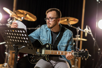 man playing guitar at studio rehearsal
