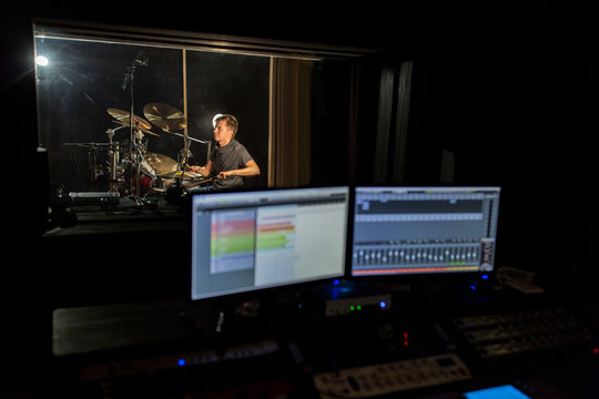 man playing drum kit at sound recording studio