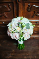 Beautiful bridal bouquet on the wooden background