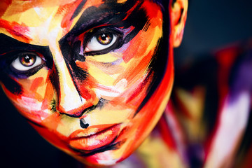Portrait of the bright beautiful girl with art colorful make-up and bodyart