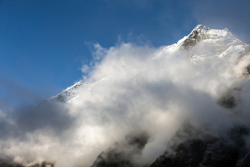 Fototapeta na wymiar View of Mountain Peak and massive Cloud Front