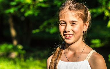 Portrait of a beautiful and happy girl in the Park