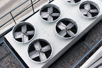 Steel ventilators with spinning blades placed outside the building and used for office...