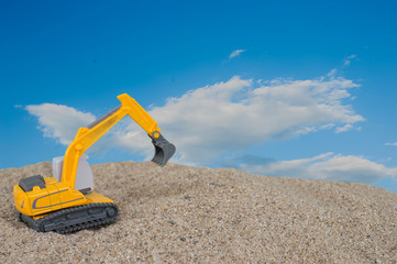 Construction ig excavator on new construction site, in the background the blue sky