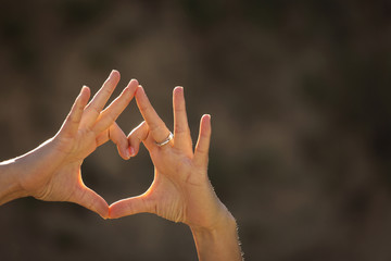 Woman hands making a heart shape on a white isolated background. - obrazy, fototapety, plakaty