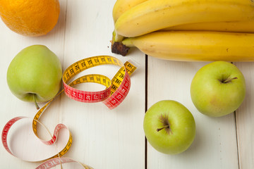 Fruits and diet plan on a white wooden table