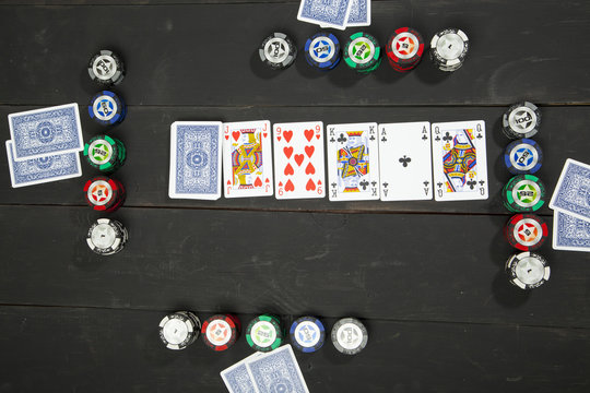 Playing poker on black wooden table