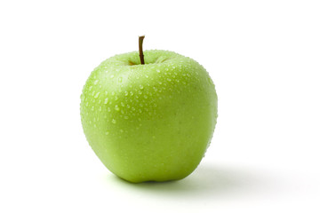 Green wet apple with water drops on white background