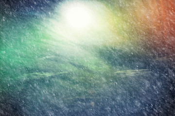 Dark sky with snow storm clouds and northern lights