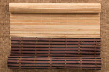 Two bamboo mat twisted in the form of a manuscript on sackcloth