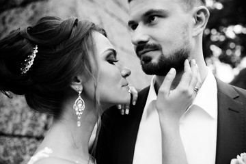 Young wedding couple enjoying romantic moments outside