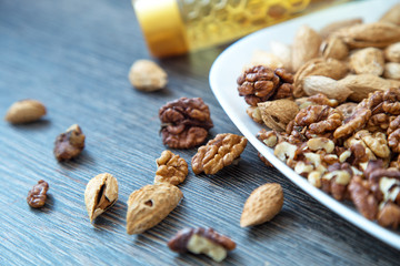 Nuts  background. Nuts in a white plate with honey