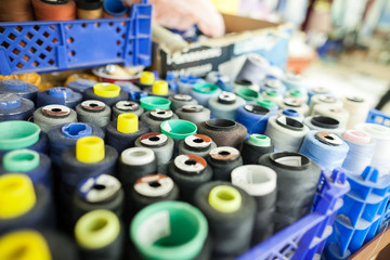 threads for sewing in a workshop. it is a lot of threads for sewing in a box.