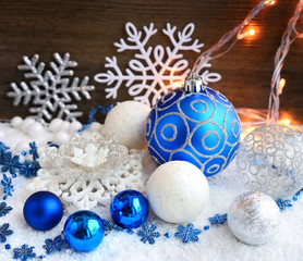 Fototapeta na wymiar Christmas decorative balls on snow and Christmas lights. 